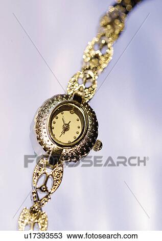Stock Image - close-up, watch, golden, white background. Fotosearch