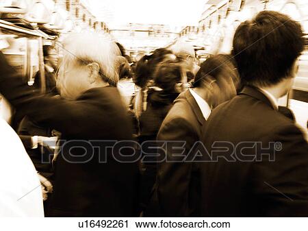 Stock Image - Blurred, Bullet Train, Large Group Of People, Formal Clothing, Head And Shoulders. Fotosearch