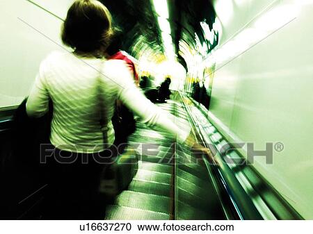 Stock Image - Carrying, Holding, Escalator, Indoor. Fotosearch