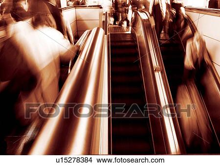 Picture - Carrying, Holding, Moving Up, Escalator, Indoor. Fotosearch