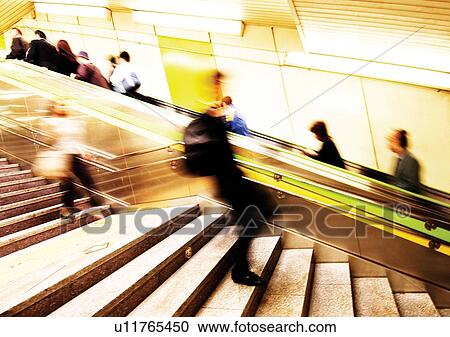Stock Image - Carrying, Holding, Moving Up, Escalator, Indoor. Fotosearch