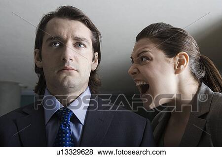 Stock Photo - Businesswoman shouting to businessman. Fotosearch