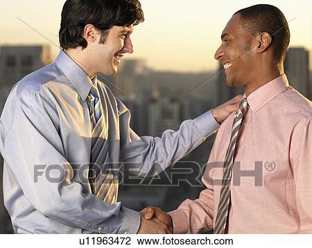 Two businessmen shaking hands View Large Photo Image Stock Image - Two businessmen shaking hands. Fotosearch
