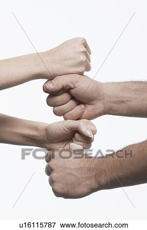 Stock Photo - Woman and man stacking fists, close-up. Fotosearch