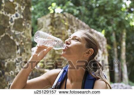 Stock Photo - Female hiker drinking water. Fotosearch