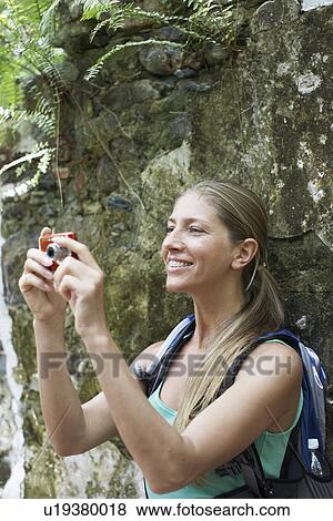Female hiker taking photograph View Large Photo Image Stock Photo - Female hiker taking photograph. Fotosearch