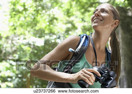 Stock Photograph - Female hiker with binoculars. Fotosearch