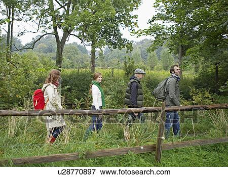 Stock Photo - Four People Hiking. Fotosearch