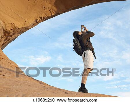 Male hiker playing bugle, low angle view View Large Photo Image Stock Image - Male hiker playing bugle, low angle view. Fotosearch