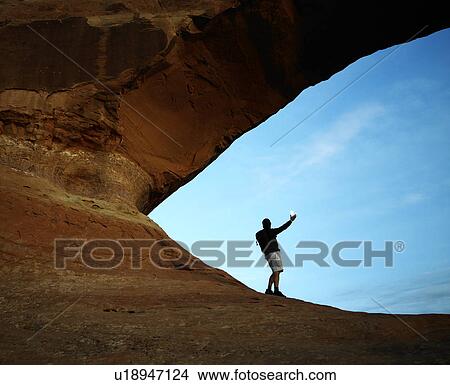 Picture - Male Hiker Signaling with Mirror. Fotosearch