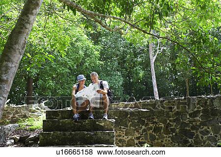 Mid adult couple hiking in old ruins View Large Photo Image Stock Photo - Mid adult couple hiking in old ruins. Fotosearch