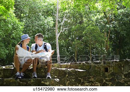 Mid adult couple reading map on ruins View Large Photo Image Stock Image - Mid adult couple reading map on ruins. Fotosearch