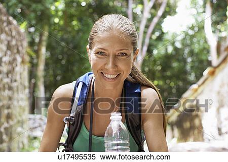 Portrait of female hiker with water bottle View Large Photo Image Stock Photography - Portrait of female hiker with water bottle. Fotosearch