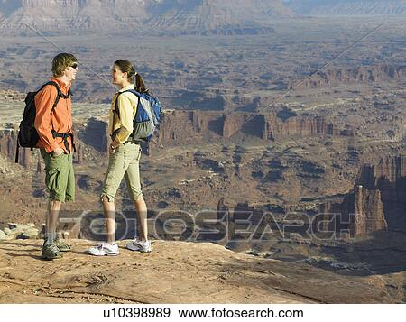 Two hikers looking at rock strata View Large Photo Image Stock Photo - Two hikers looking at rock strata. Fotosearch