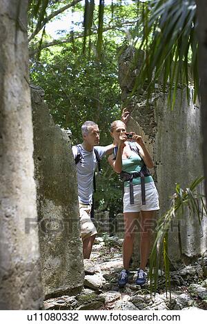 Two hikers photographing at ruins View Large Photo Image Stock Image - Two hikers photographing at ruins. Fotosearch