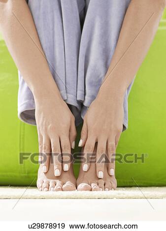 Hands on bare feet (close-up) View Large Photo Image Stock Photo - Hands on bare feet (close-up). Fotosearch