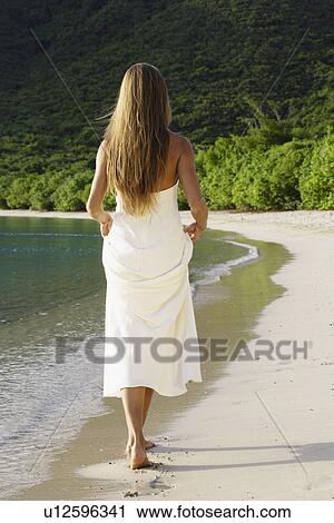 Mid adult woman in wedding dress walking on beach, St John, US Virgin Islands, USA View Large Photo Image Stock Image - Mid adult woman in wedding dress walking on beach, St John, US Virgin Islands, USA. Fotosearch