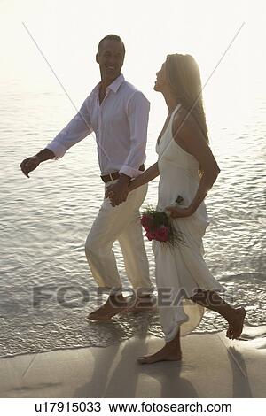 Newlyweds walking on sandy beach, St John, US Virgin Islands, USA View Large Photo Image Stock Image - Newlyweds walking on sandy beach, St John, US Virgin Islands, USA. Fotosearch