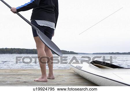 Senior man holding oar by kayak (low section) View Large Photo Image Stock Photography - Senior man holding oar by kayak (low section). Fotosearch