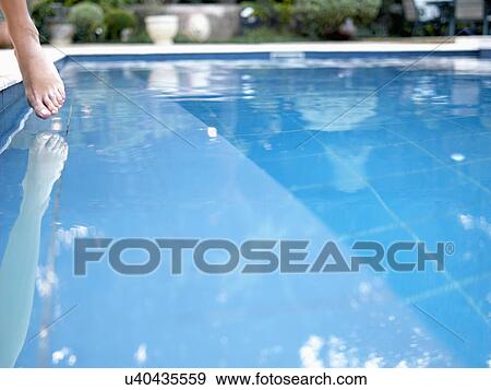 Toe dipping in swimming pool (close-up) View Large Photo Image Stock Photo - Toe dipping in swimming pool (close-up). Fotosearch