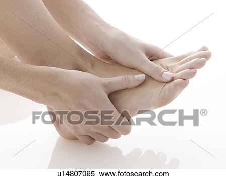 Woman rubbing her foot (close-up) View Large Photo Image Stock Photography - Woman rubbing her foot (close-up). Fotosearch