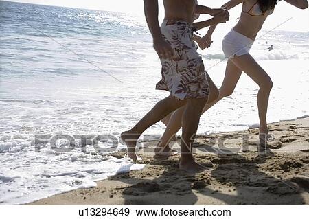 Young adult people having fun on beach, Side View View Large Photo Image Stock Photo - Young adult people having fun on beach, Side View. Fotosearch
