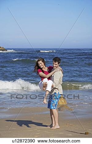 Stock Image - Young Couple at Beach. Fotosearch