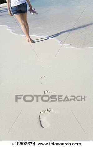 Woman and her footprints on beach sand, Saipan, USA View Large Photo Image Picture - Woman and her footprints on beach sand, Saipan, USA . Fotosearch