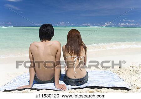 Young couple sitting on beach, Saipan, USA View Large Photo Image Stock Image - Young couple sitting on beach, Saipan, USA . Fotosearch