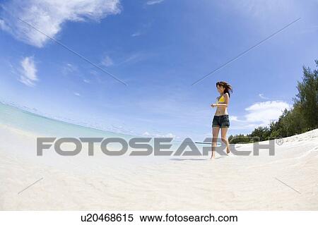Young woman running on beach, fish-eye lens, Saipan, USA View Large Photo Image Stock Photography - Young woman running on beach, fish-eye lens, Saipan, USA . Fotosearch