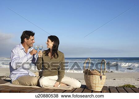 Couple drinking wine on beach, Cape Town, South Africa View Large Photo Image Stock Photo - Couple drinking wine on beach, Cape Town, South Africa. Fotosearch