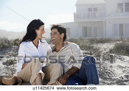 Couple laughing at beach View Large Photo Image Picture - Couple laughing at beach. Fotosearch