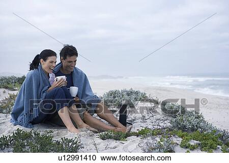 Mid adult couple drinking tea on beach, Cape Town, South Africa View Large Photo Image Stock Image - Mid adult couple drinking tea on beach, Cape Town, South Africa. Fotosearch