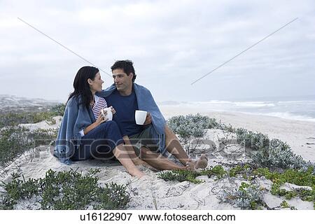 Mid adult couple drinking tea on beach, Cape Town, South Africa View Large Photo Image Stock Photo - Mid adult couple drinking tea on beach, Cape Town, South Africa. Fotosearch