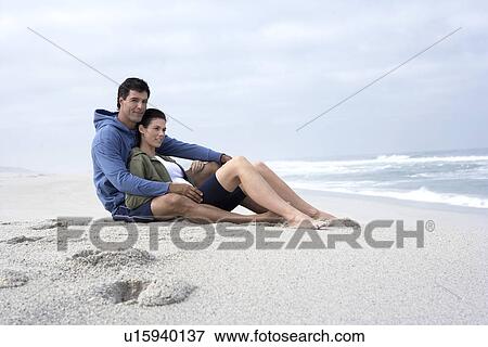Mid adult couple sitting on sandy beach, Cape Town, South Africa View Large Photo Image Stock Photo - Mid adult couple sitting on sandy beach, Cape Town, South Africa. Fotosearch