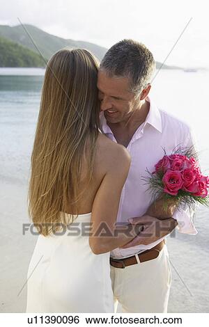 Newlyweds hugging on beach, St John, US Virgin Islands, USA View Large Photo Image Stock Photograph - Newlyweds hugging on beach, St John, US Virgin Islands, USA. Fotosearch
