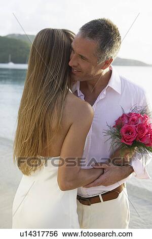 Newlyweds hugging on beach, St John, US Virgin Islands, USA View Large Photo Image Stock Photograph - Newlyweds hugging on beach, St John, US Virgin Islands, USA. Fotosearch