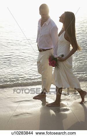 Picture - Newlyweds walking on sandy beach, St John, US Virgin Islands, USA. Fotosearch