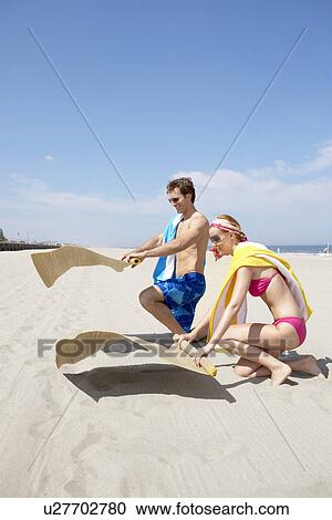 Young couple spreading beach mats on beach, Spring Lake, New Jersey, USA View Large Photo Image Stock Image - Young couple spreading beach mats on beach, Spring Lake, New Jersey, USA. Fotosearch