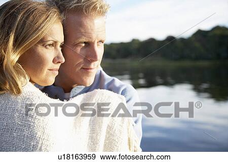 Couple wrapped in towel looking at view View Large Photo Image Stock Photo - Couple wrapped in towel looking at view. Fotosearch