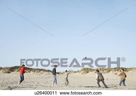 Five people playing with ball on beach View Large Photo Image Stock Image - Five people playing with ball on beach. Fotosearch