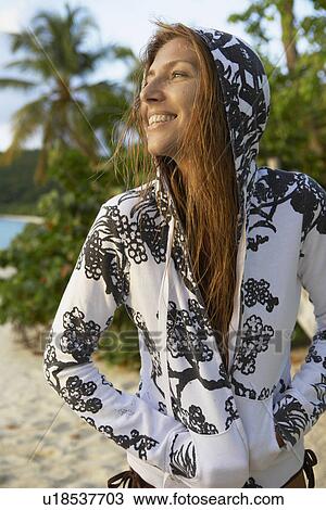 Mid adult woman in hooded top on beach View Large Photo Image Stock Image - Mid adult woman in hooded top on beach. Fotosearch