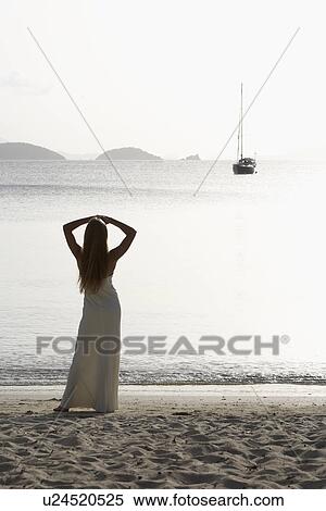 Mid adult woman looking at sailboat in sea, St. John, US Virgin Islands, USA View Large Photo Image Stock Photography - Mid adult woman looking at sailboat in sea, St. John, US Virgin Islands, USA. Fotosearch