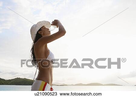 Young woman in sunhat drinking water on beach, St. John, US Virgin Islands, USA View Large Photo Image Stock Image - Young woman in sunhat drinking water on beach, St. John, US Virgin Islands, USA. Fotosearch