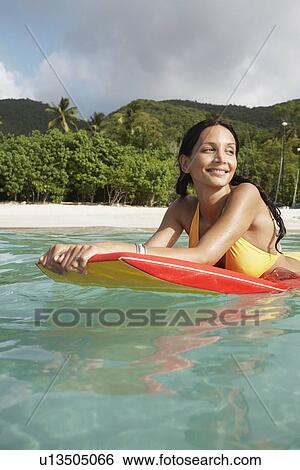 Young woman swimming with bodyboard, St. John, US Virgin Islands, USA View Large Photo Image Stock Photograph - Young woman swimming with bodyboard, St. John, US Virgin Islands, USA. Fotosearch