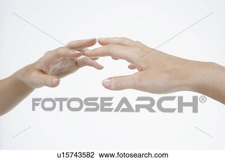 Stock Image - Hand touching mirror, close-up. Fotosearch
