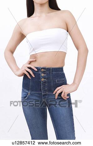 Stock Image - Woman wearing jeans, front view. Fotosearch