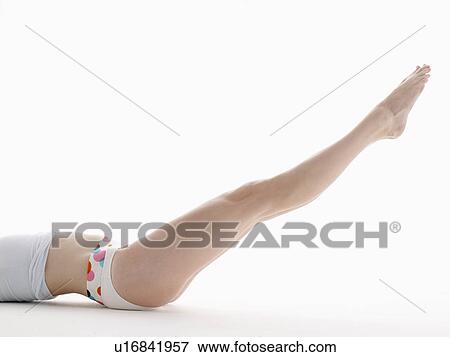 Young woman raising legs (low section) View Large Photo Image Stock Photo - Young woman raising legs (low section). Fotosearch