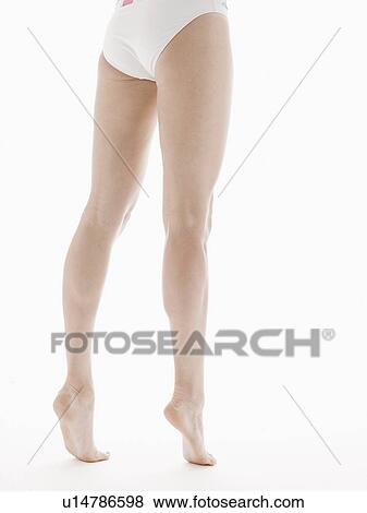 Young woman standing on toes (low section) View Large Photo Image Stock Photo - Young woman standing on toes (low section). Fotosearch