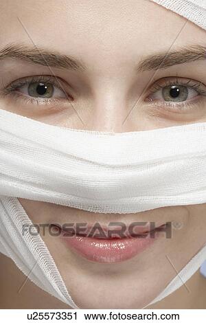 Bandage around woman's face, close-up View Large Photo Image Stock Image - Bandage around woman's face, close-up. Fotosearch